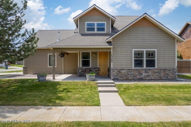 15360 N Nixon Loop, Rathdrum, ID 83858 - view of front of property featuring a front yard, roof with shingles, and stone siding