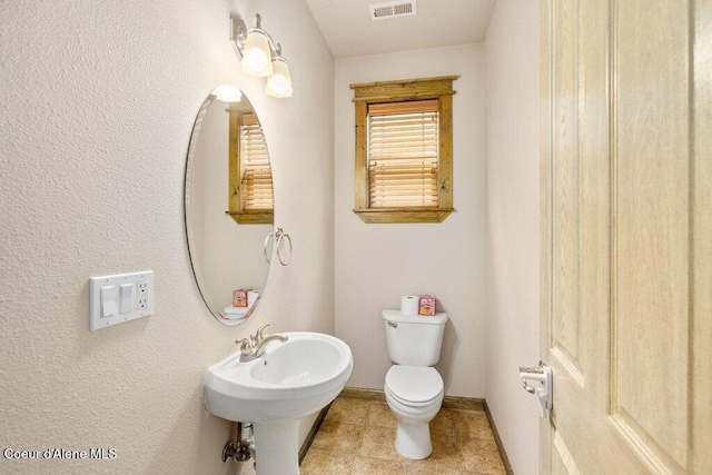 15360 N Nixon Loop, Rathdrum, ID 83858 - bathroom featuring toilet, baseboards, and a sink