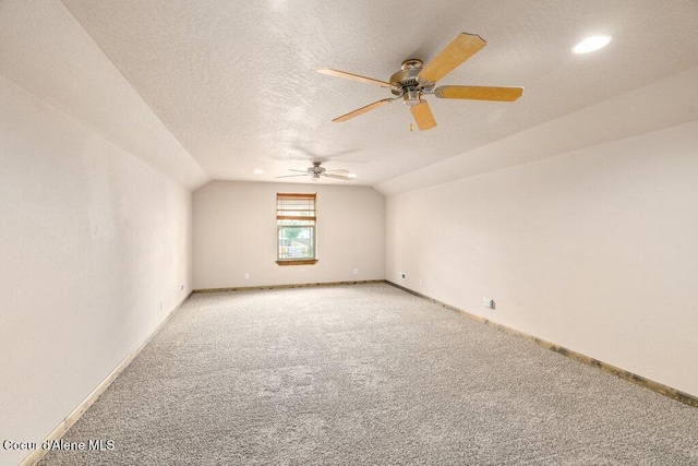 15360 N Nixon Loop, Rathdrum, ID 83858 - additional living space featuring light colored carpet, vaulted ceiling, baseboards, ceiling fan, and a textured ceiling