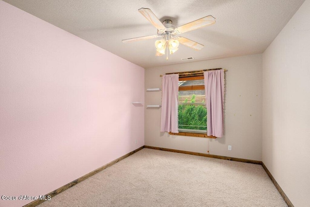 15360 N Nixon Loop, Rathdrum, ID 83858 - empty room featuring light carpet, baseboards, a ceiling fan, and a textured ceiling