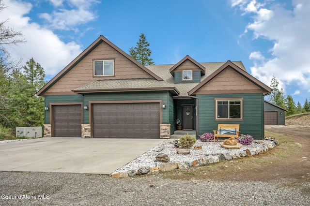 29264 N Ramsey Rd, Athol, ID 83801 - craftsman house featuring driveway, a garage, roof with shingles, and stone siding