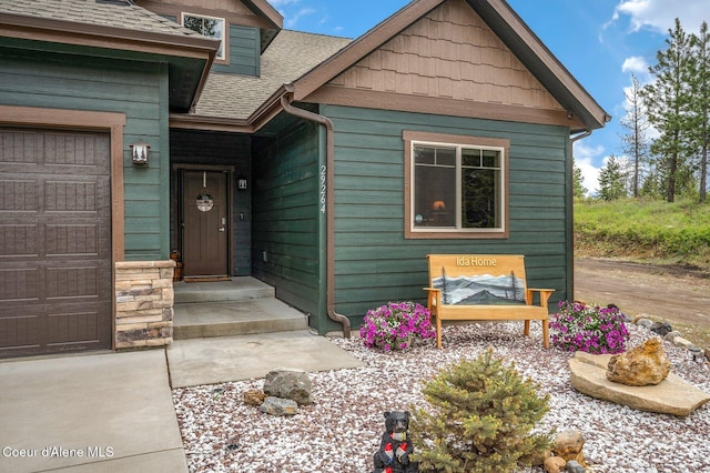 29264 N Ramsey Rd, Athol, ID 83801 - entrance to property with a shingled roof and a garage