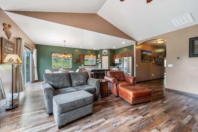 29264 N Ramsey Rd, Athol, ID 83801 - living room featuring wood finished floors, a chandelier, arched walkways, baseboards, and high vaulted ceiling