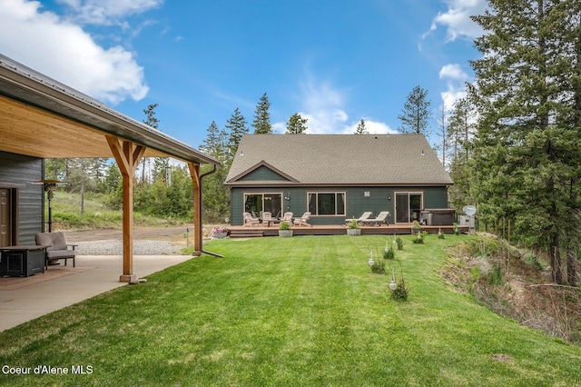 29264 N Ramsey Rd, Athol, ID 83801 - back of house featuring a wooden deck, a yard, a shingled roof, and a patio area
