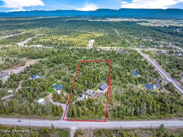 29264 N Ramsey Rd, Athol, ID 83801 - aerial overview of property's location with a heavily wooded area, mountains, and property boundaries highlighted