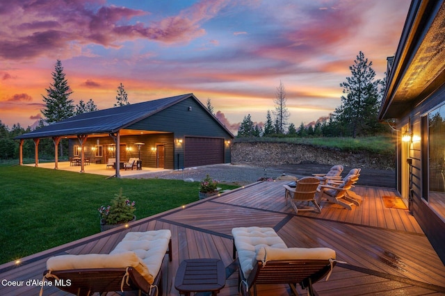29264 N Ramsey Rd, Athol, ID 83801 - deck at dusk with a garage, a yard, and an outbuilding