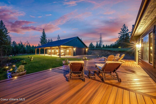 29264 N Ramsey Rd, Athol, ID 83801 - wooden terrace with a lawn, an outbuilding, and a garage