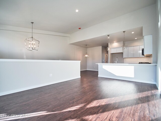 898 E Railroad Ave, Post Falls, ID 83854 - unfurnished living room with a chandelier, dark wood-style floors, a sink, baseboards, and recessed lighting