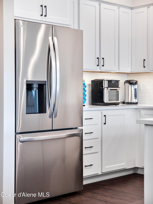 898 E Railroad Ave, Post Falls, ID 83854 - kitchen with stainless steel refrigerator with ice dispenser, tasteful backsplash, white cabinets, light countertops, and dark wood-style floors