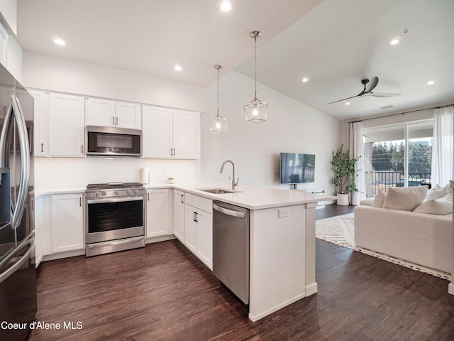 898 E Railroad Ave, Post Falls, ID 83854 - kitchen featuring appliances with stainless steel finishes, a sink, open floor plan, a peninsula, and recessed lighting