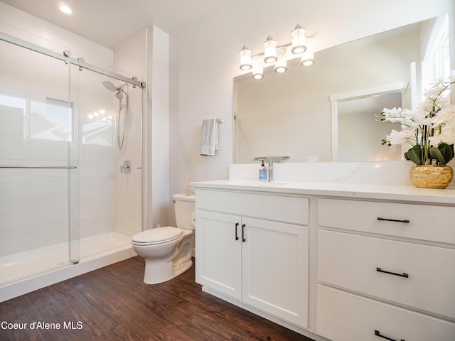 898 E Railroad Ave, Post Falls, ID 83854 - bathroom featuring toilet, a shower stall, vanity, and wood finished floors