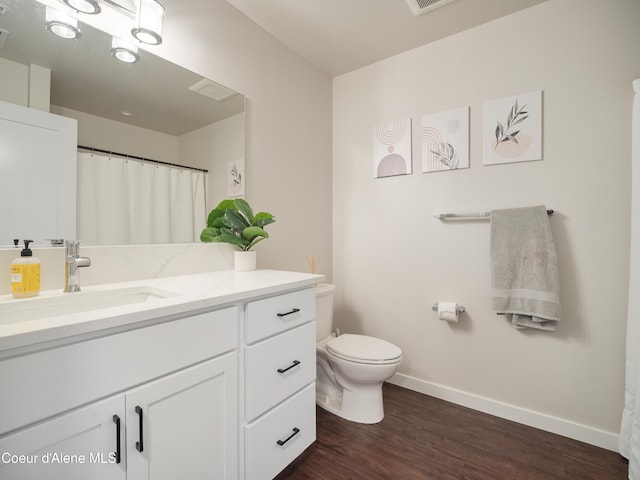 898 E Railroad Ave, Post Falls, ID 83854 - full bathroom featuring toilet, baseboards, vanity, and wood finished floors