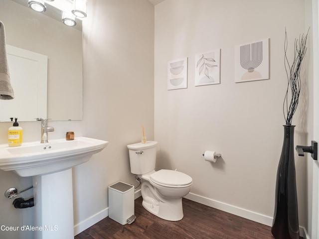 898 E Railroad Ave, Post Falls, ID 83854 - bathroom with baseboards, toilet, and wood finished floors