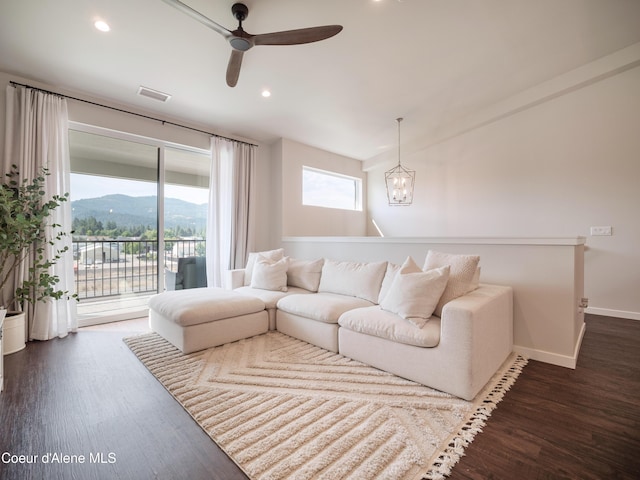 898 E Railroad Ave, Post Falls, ID 83854 - living room featuring dark wood-style flooring, a ceiling fan, baseboards, a mountain view, and a chandelier