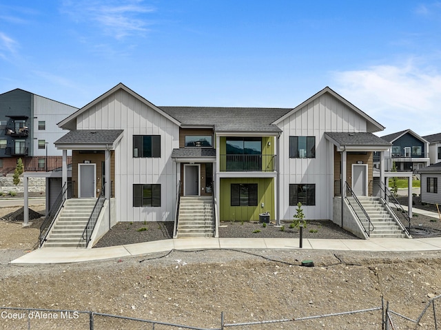 898 E Railroad Ave, Post Falls, ID 83854 - view of front of property featuring board and batten siding, stairs, a shingled roof, and a balcony