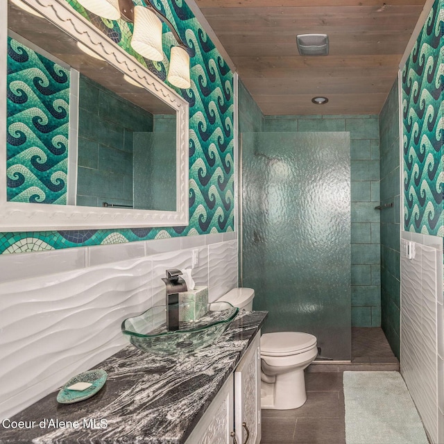 23 S Lightning Spur Ln, Coeur Dalene, ID 83814 - bathroom with wallpapered walls, vanity, a tile shower, toilet, and wood ceiling
