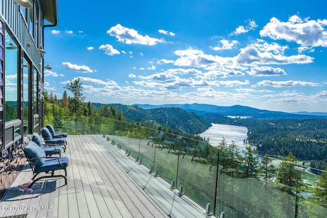 23 S Lightning Spur Ln, Coeur Dalene, ID 83814 - deck featuring a mountain view and a view of trees