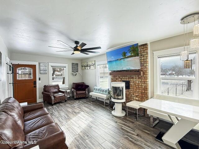 372 E Jefferson Ave, Priest River, ID 83856 - living room featuring wood finished floors, a ceiling fan, and a fireplace