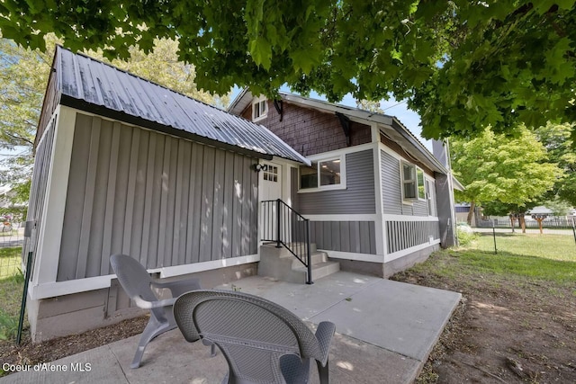 372 E Jefferson Ave, Priest River, ID 83856 - back of house with a patio area, board and batten siding, and metal roof