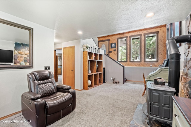 3470 W Seasons Rd, Rathdrum, ID 83858 - carpeted living room featuring baseboards, wooden walls, and a textured ceiling