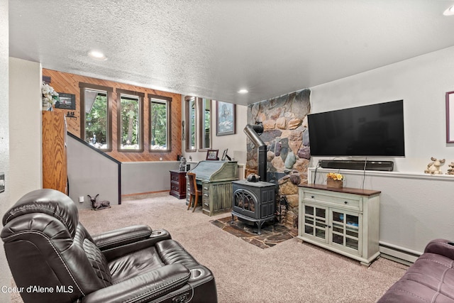 3470 W Seasons Rd, Rathdrum, ID 83858 - carpeted living room with a baseboard radiator, a wood stove, and recessed lighting