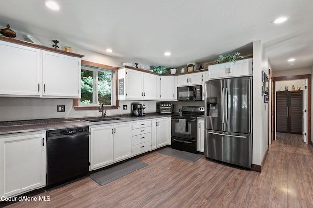 3470 W Seasons Rd, Rathdrum, ID 83858 - kitchen with black appliances, a sink, dark countertops, dark wood-style floors, and recessed lighting