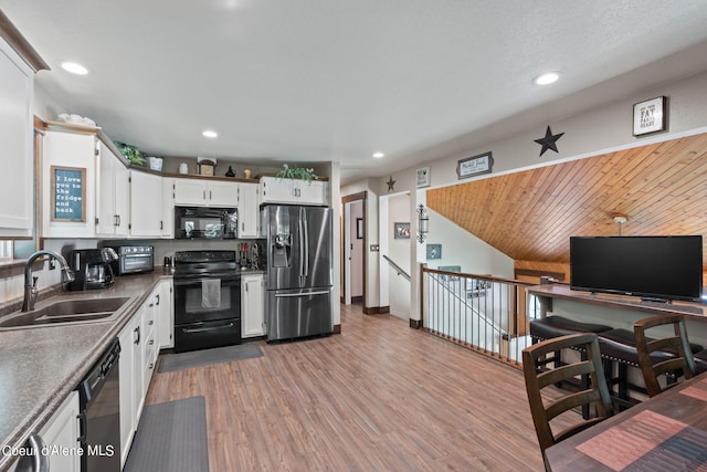 3470 W Seasons Rd, Rathdrum, ID 83858 - kitchen with black appliances, a sink, wood finished floors, white cabinetry, and recessed lighting