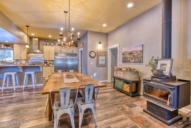 348 Kootenai Trail Rd, Naples, ID 83847 - dining room with a wood stove, recessed lighting, a chandelier, and wood finished floors