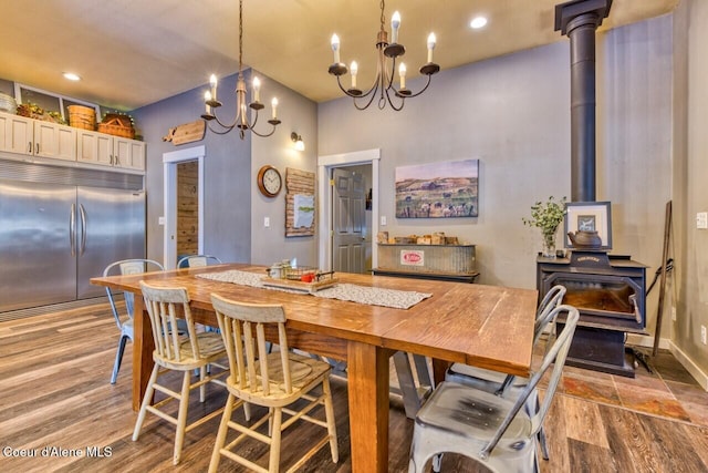 348 Kootenai Trail Rd, Naples, ID 83847 - dining room with a wood stove, a chandelier, light wood-type flooring, baseboards, and recessed lighting