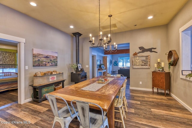 348 Kootenai Trail Rd, Naples, ID 83847 - dining area with a chandelier, dark wood finished floors, recessed lighting, baseboards, and a wood stove