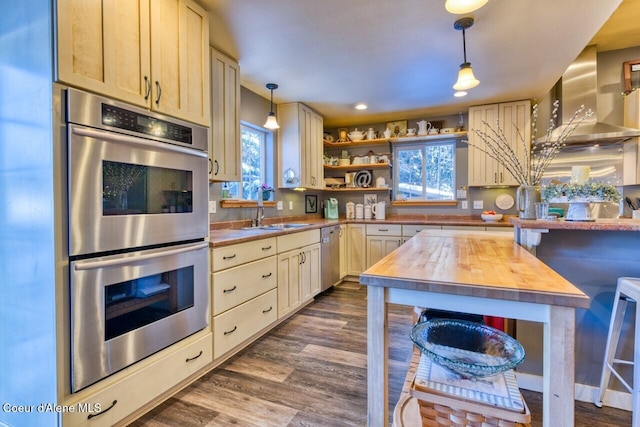 348 Kootenai Trail Rd, Naples, ID 83847 - kitchen with appliances with stainless steel finishes, butcher block countertops, a sink, wall chimney range hood, and decorative light fixtures