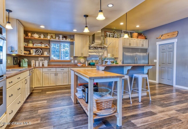 348 Kootenai Trail Rd, Naples, ID 83847 - kitchen with appliances with stainless steel finishes, wall chimney range hood, recessed lighting, dark wood-style flooring, and pendant lighting
