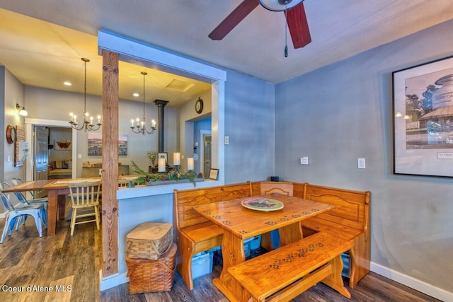 348 Kootenai Trail Rd, Naples, ID 83847 - dining area featuring a chandelier, wood finished floors, a ceiling fan, and baseboards