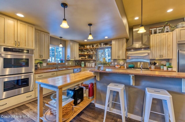 348 Kootenai Trail Rd, Naples, ID 83847 - kitchen featuring double oven, a sink, plenty of natural light, wall chimney exhaust hood, and recessed lighting
