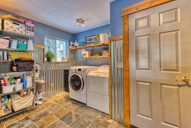 348 Kootenai Trail Rd, Naples, ID 83847 - laundry room with washing machine and clothes dryer and stone finish floors