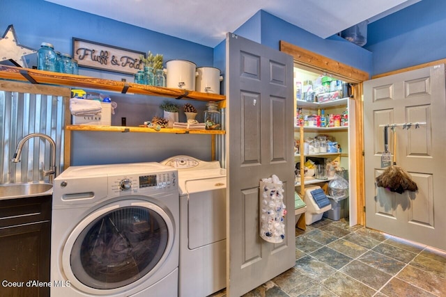 348 Kootenai Trail Rd, Naples, ID 83847 - laundry area with cabinet space, washing machine and clothes dryer, and dark stone finish floors