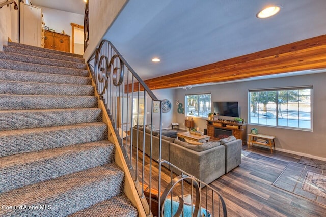 348 Kootenai Trail Rd, Naples, ID 83847 - stairway with recessed lighting, wood finished floors, a lit fireplace, and baseboards