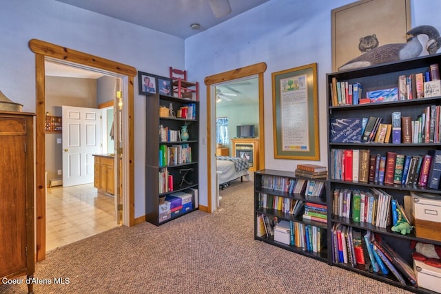 348 Kootenai Trail Rd, Naples, ID 83847 - living area with ceiling fan, carpet floors, a glass covered fireplace, and baseboards