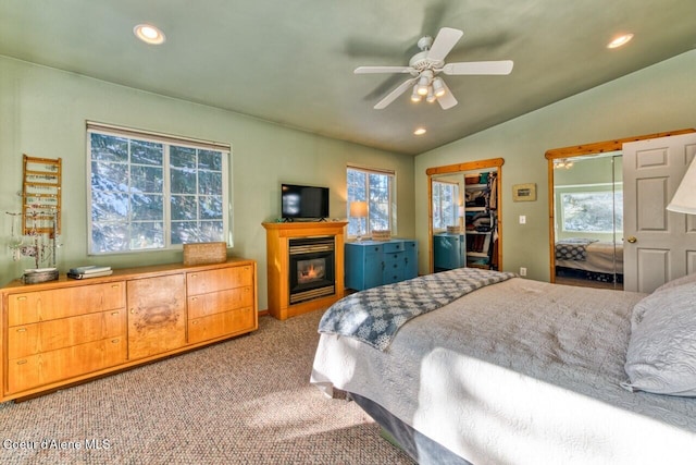 348 Kootenai Trail Rd, Naples, ID 83847 - carpeted bedroom with lofted ceiling, recessed lighting, a glass covered fireplace, and ceiling fan