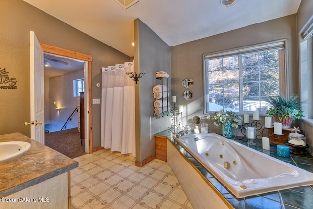 348 Kootenai Trail Rd, Naples, ID 83847 - bathroom featuring a tub with jets, vanity, tile patterned floors, and baseboards