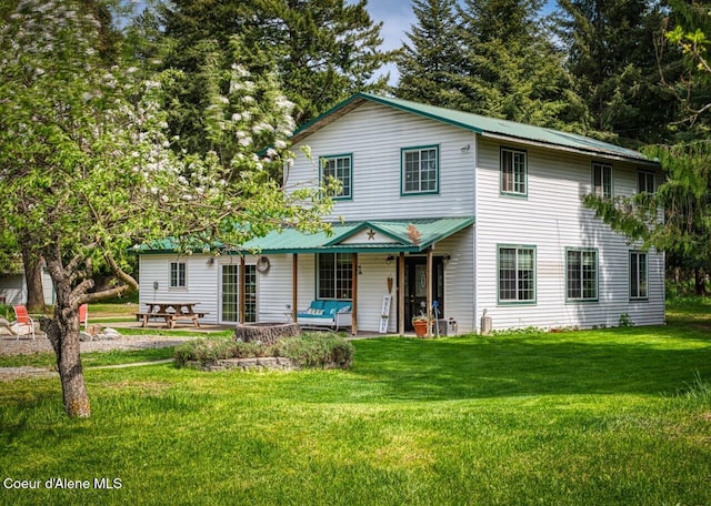 348 Kootenai Trail Rd, Naples, ID 83847 - view of front facade with a front lawn, metal roof, and a patio area