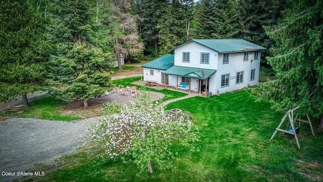 348 Kootenai Trail Rd, Naples, ID 83847 - back of property with metal roof, a lawn, and a view of trees