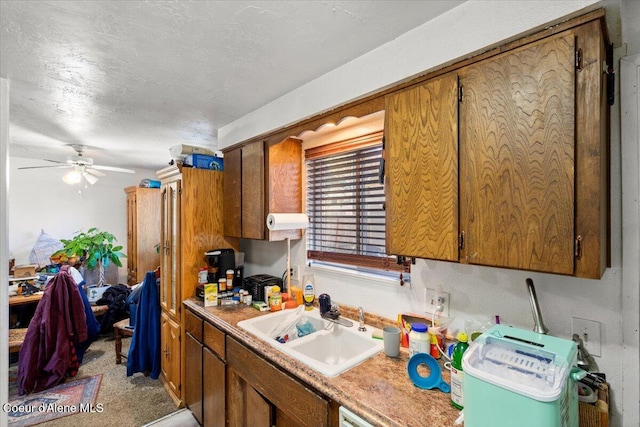 2707-2709 N 10th St, Coeur Dalene, ID 83815 - kitchen with a sink, brown cabinetry, light countertops, ceiling fan, and a textured ceiling