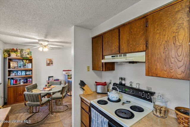 2707-2709 N 10th St, Coeur Dalene, ID 83815 - kitchen with under cabinet range hood, range with electric cooktop, ceiling fan, a textured ceiling, and brown cabinets