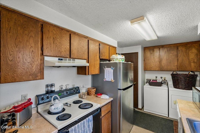 2707-2709 N 10th St, Coeur Dalene, ID 83815 - kitchen featuring under cabinet range hood, range with electric stovetop, independent washer and dryer, brown cabinetry, and light countertops