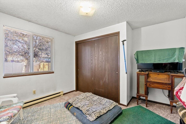 2707-2709 N 10th St, Coeur Dalene, ID 83815 - carpeted bedroom featuring baseboard heating, a closet, a textured ceiling, and baseboards