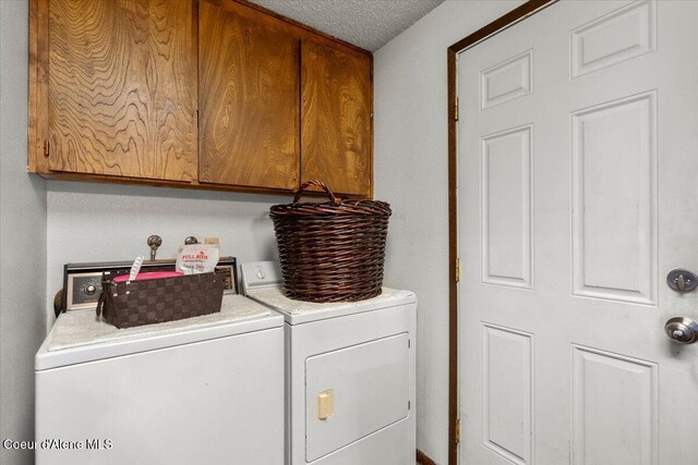 2707-2709 N 10th St, Coeur Dalene, ID 83815 - laundry area with washer and clothes dryer, cabinet space, and a textured ceiling