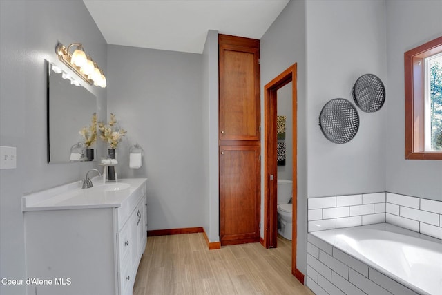320 S River St, Rockford, WA 99030 - full bath with wood finished floors, vanity, toilet, a bath, and baseboards
