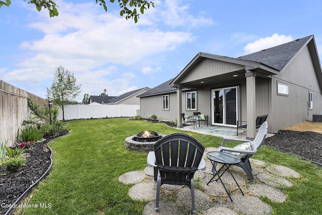 18924 E Fredrick Ave, Otis Orchards, WA 99027 - back of property featuring a fire pit, a patio, roof with shingles, and central AC unit