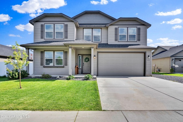 6314 Irish Dr, Rathdrum, ID 83858 - view of front of home with driveway, a front yard, an attached garage, and a shingled roof